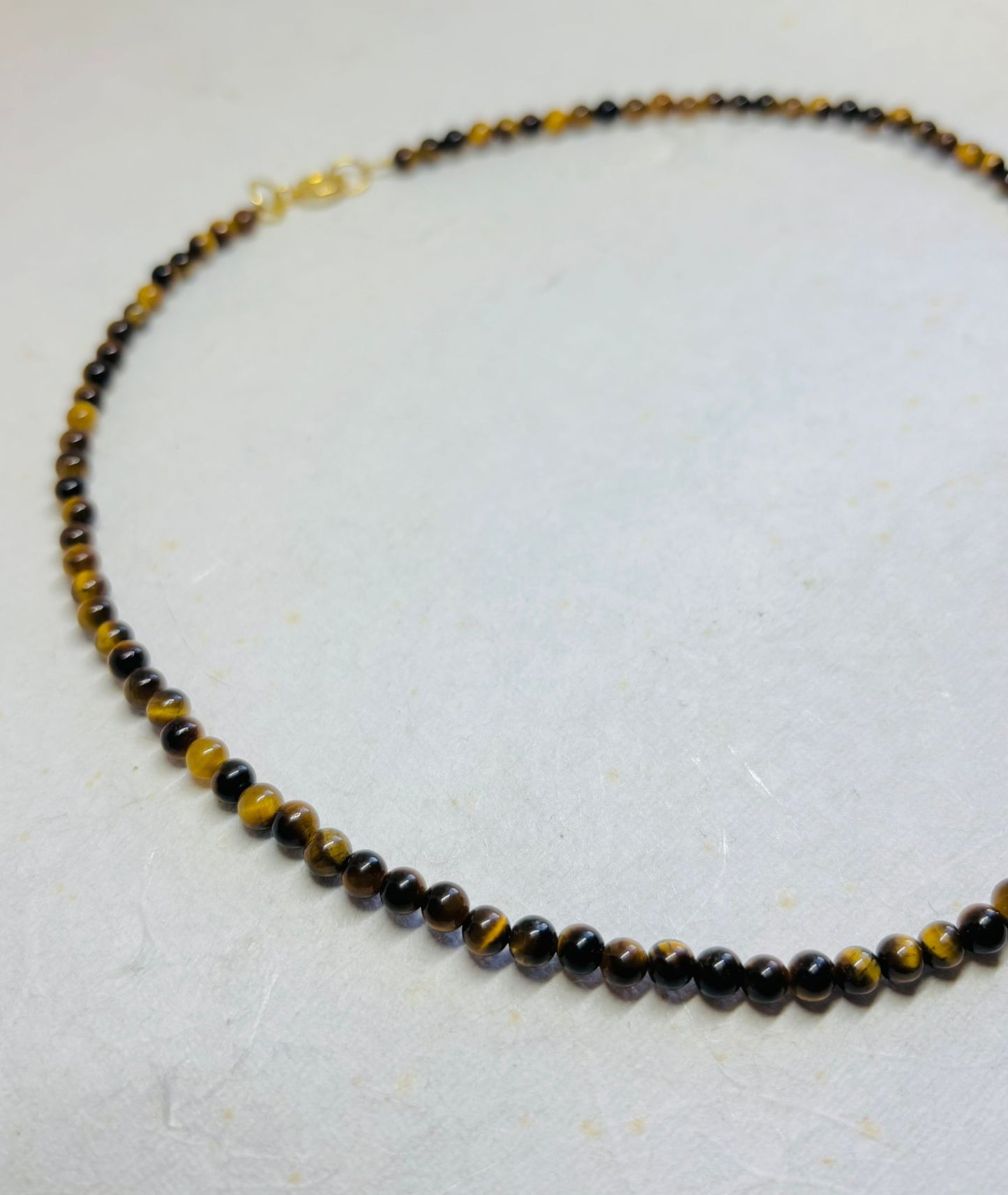 Ketting tijgeroog met goudkleurig slotje